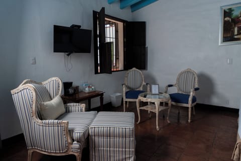 Coronel Suite, King bed, garden area | Living area | 32-inch plasma TV with satellite channels, TV, heated floors