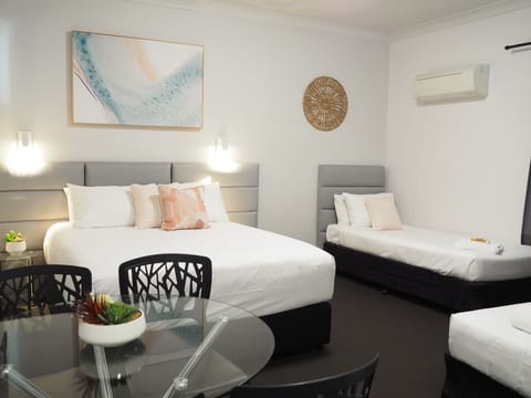 Deluxe Quadruple Room | Pillowtop beds, blackout drapes, iron/ironing board, free WiFi