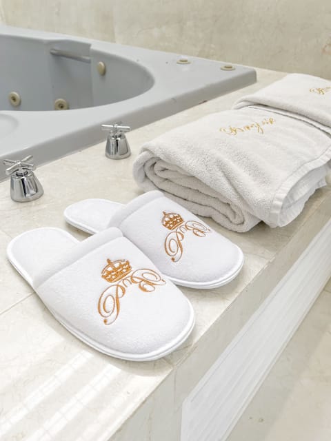 Designer toiletries, hair dryer, slippers, towels