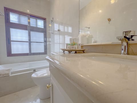 Deluxe Room | Bathroom | Designer toiletries, hair dryer, slippers, towels