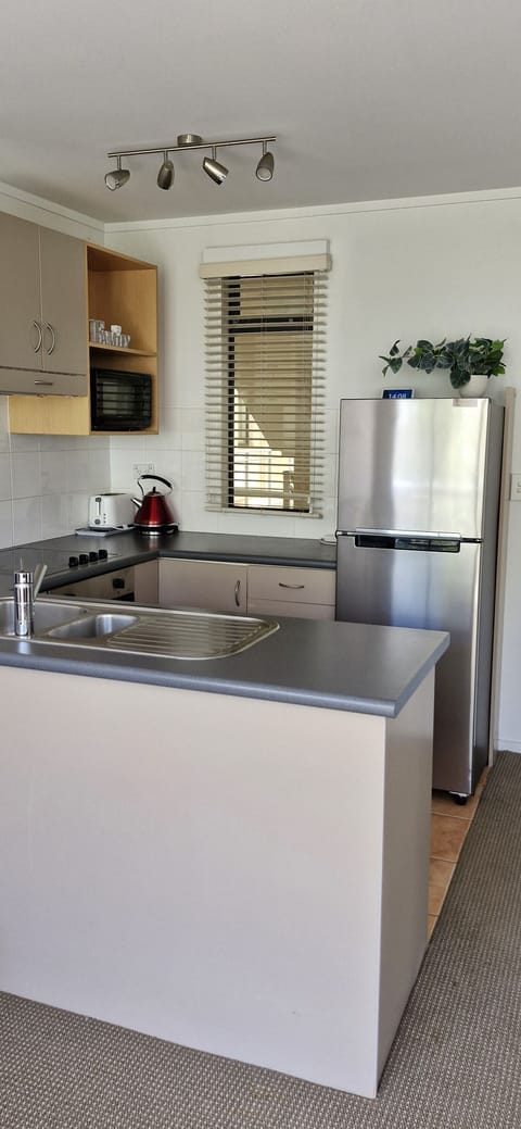 2 Bedroom Apartment (Pool View) | Private kitchen | Full-size fridge, microwave, oven, stovetop