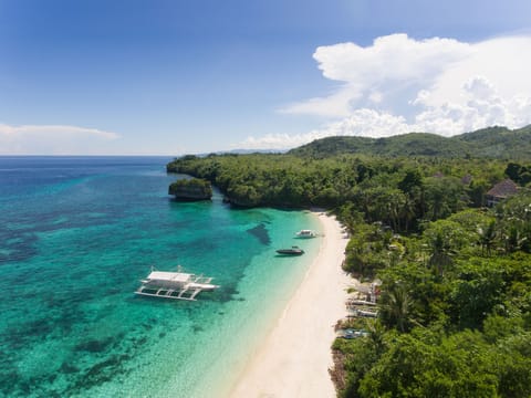 On the beach, white sand, sun loungers, beach umbrellas