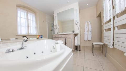 Suite, 1 King Bed | Bathroom | Free toiletries, hair dryer, bathrobes, slippers