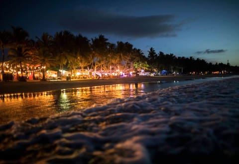 On the beach, white sand, sun loungers, beach towels