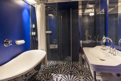 Legacy Corner Suite | Bathroom | Designer toiletries, hair dryer, bathrobes, slippers