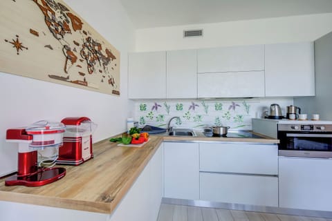 Family Apartment, 1 Bedroom (Una Meta Tra Gli Ulivi) | Private kitchen | Fridge, microwave, oven, stovetop