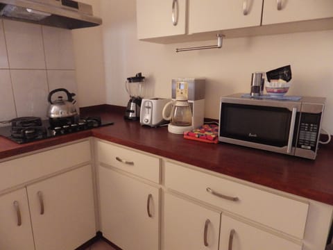 Apartment, 1 Bedroom, Pool View | Private kitchen | Full-size fridge, microwave, stovetop, coffee/tea maker