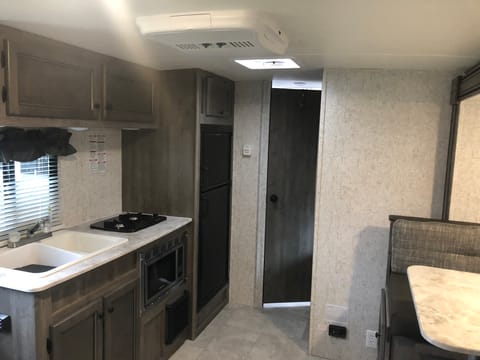 Double sink, stove, microwave and fridge