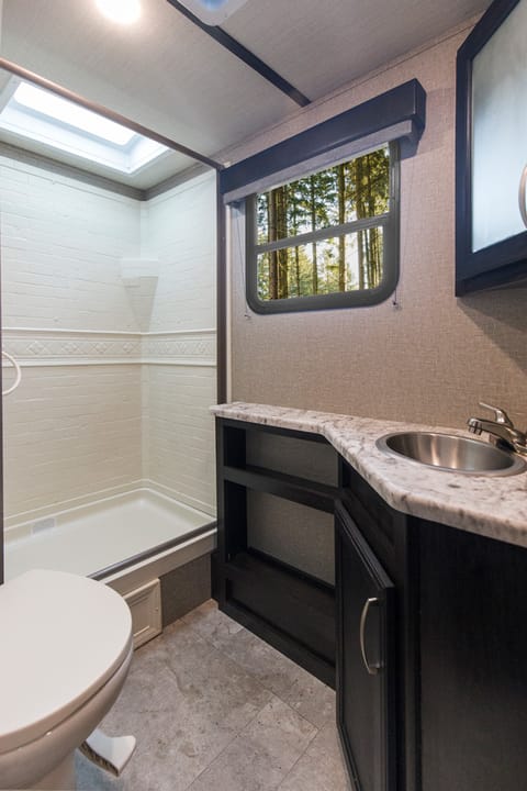 bathroom with an xtra large shower and porcelain toilet 