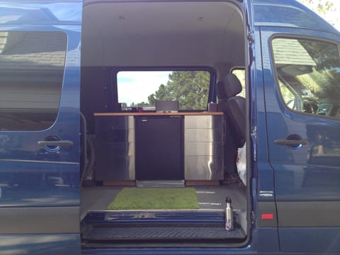 The galley has a small sink, 12v DC fridge, and 4 drawers. 
*Overhead cabinet and lighting were added after this photo.