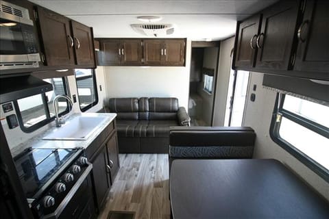 The bedroom in the back has a door that shuts it off from the rest of the trailer. The bed in it is Queen size. The AC is in the ceiling and the heat is central heat. 