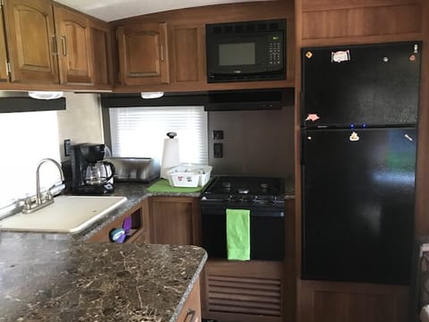 Kitchen has microwave, oven, stove top, double sink, refrigerator & freezer; Included: Dishes for 6 including glassware. All necessary sponges, dish detergent; 3 pots with lids and skillet; plates for 4; paper plate; ice trays & maker for summer usage. Has toaster, coffee maker and Insta-pot for quick meals.