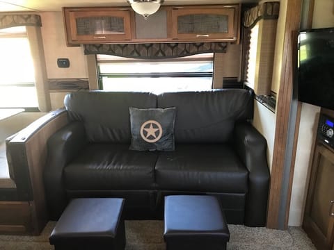 Couch has pull out double bed that sleeps 2-adults; Regular full recliner in den; Pull out mounted 35" TV with DVD. Trashcan, broom w/dustpan  and umbrella mounted inside door for your convenience