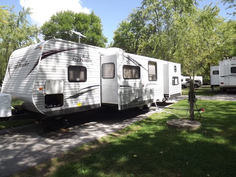 Exterior. Pictured is the back of the trailer, with visuals of the two slide-outs.