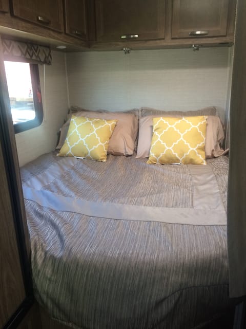 This queen size bed is located at the back of the RV.  It is right next to the bathroom.