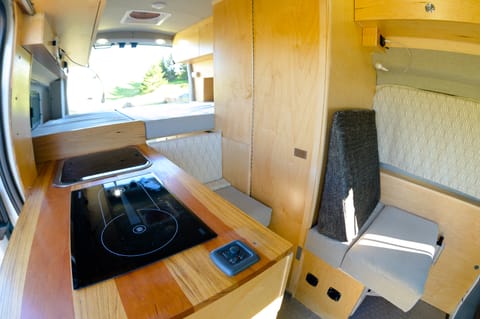 looking from the kitchen to the full double bed with complete access to the back. There is 4 person seating with seatbelts
