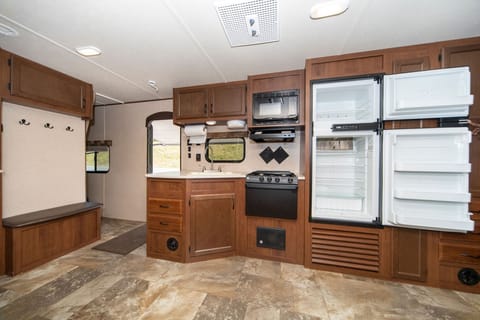 Extra roomy kitchen with microwave and large refrigerator!  Comes with dishes, pots/pans, and silverware.