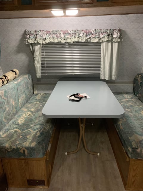 Dining area that also converts to a sleeping area for 2.  We have included a privacy curtain that you can draw across.  There is a storage area just behind the left bench where you can easily store bedding and other items.  Each bench also has storage underneath.