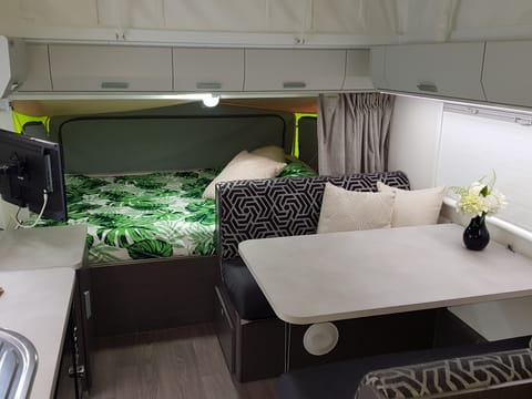 The front queen sized bed, dining area with 12v TV/DVD and aerial