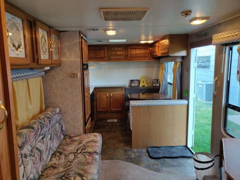 Right side of Camper when entering. Table converts to bed, sink, refrigerator and freezer, stove, oven, and LOTS of storage!