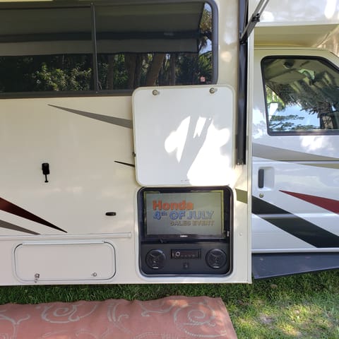 The outdoor entertainment system has a TV, stereo and DVD under the awning.