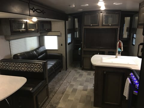 Interior from back of camper to front.  Tri-fold couch (instead of jack-knife) on front left of slide out that folds down into a bed