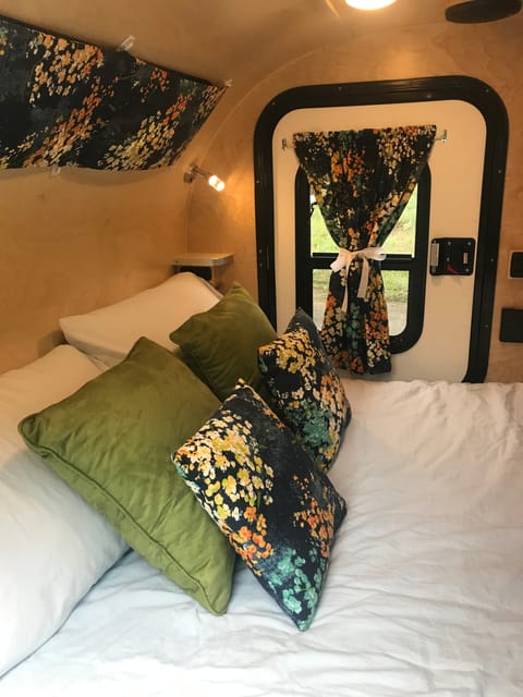 Margot's interior is cozy and colorful and features a comfy mattress and windows / doors on BOTH sides of the bed.  Need linens?  Ask for our bedding upgrade.