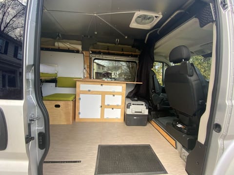 looking in from the side door. the fridge is now located on a slide toward the back of the van