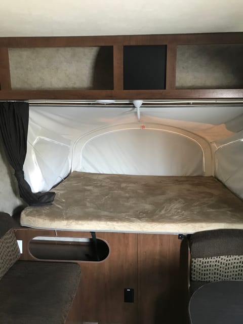 Fold out RV king bed with overhead storage 