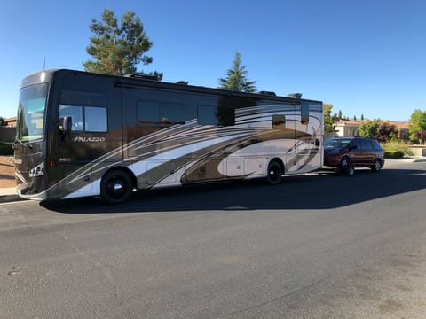 Our luxury diesel pusher RV towing our family hauler minivan.