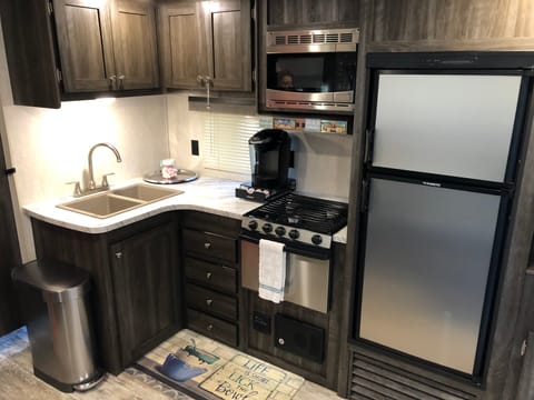 Full kitchen includes a dual sink, microwave, 3 burner stove with oven and a good sized refrigerator!