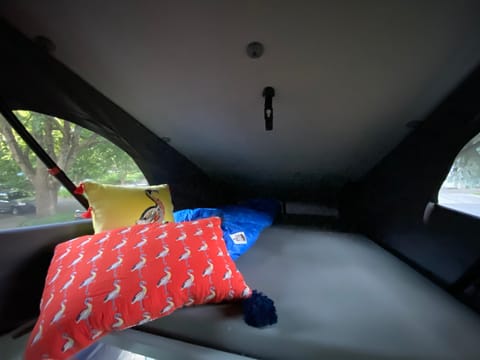 The roof of the van can be pushed up and makes into another full-size bed that sleeps two. The built-in mattress is about 2 inches thick.