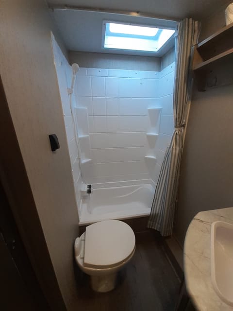 Full size shower with sunken tub