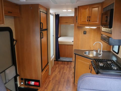 View of kitchen, bath, hallway, and master bedroom from the bed above the cab! :)