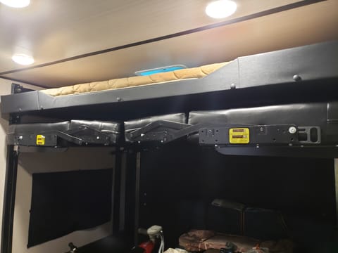 Electric double bunks in back, lower bunk folds into 2 couches