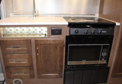 Cook top with a microwave oven below.