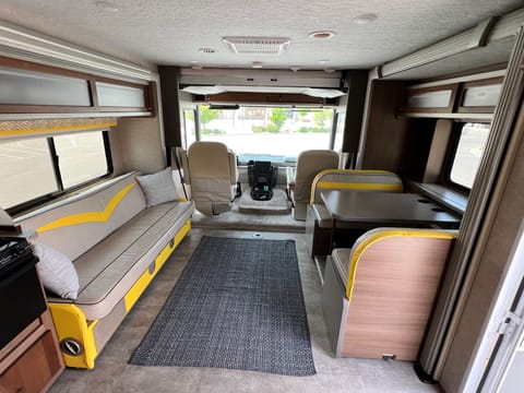 This is the main area with dining table and couch that turns into a bed. There’s also a bed above the driving compartment.