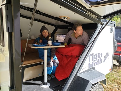 Convert the bed to the table and seat.  The gullwing door provides epic views while you dine!