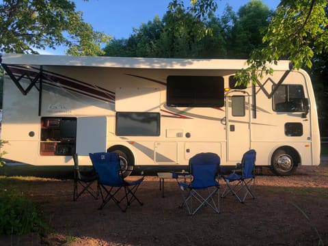 The Fun side with RV awning opened, TV, bar area, with camp chairs (also included). Ready for adventure!