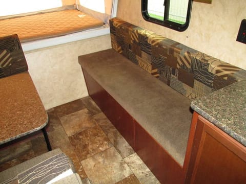 Additional bench seating with storage bin underneath, which is accessible outside.