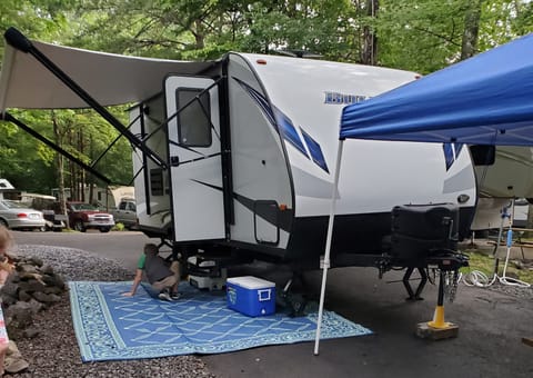 Camper setup with awning extended.