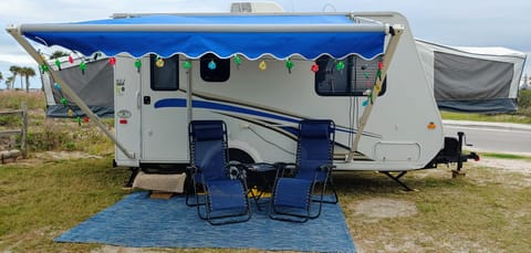 Included in outdoor setup with daily rental fee:  outdoor rug, 2 gravity chairs, camper lights.