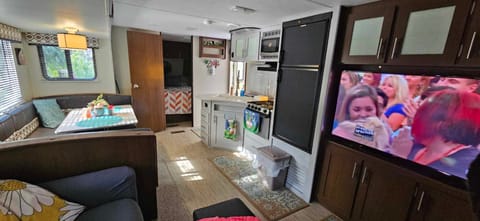 Double sink, stove, microwave, and fridge for the beer!