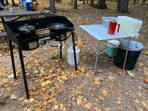 Some of the included kitchen set-up (grill, pot, pan, propane, table, french press, dish tub, garbage bag, water jugs)