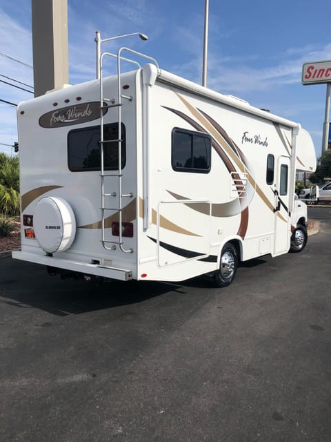 Back of RV with large storage area, site seeing windows, push button electric motorized awning.
