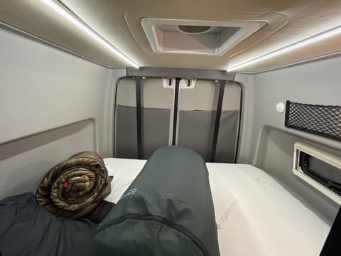 The storage area and sleep zone has a bed that lowers down. It's about a Queen size. And with the van's popouts, you get a full length bed.