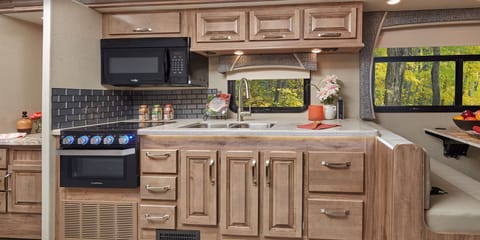 Cooking in style. Take your recipes on the road and access them easily in the Greyhawk Prestige’s roomy kitchen. A 110/USB charging station in the solid-surface kitchen countertop, a durable stainless-steel sink.