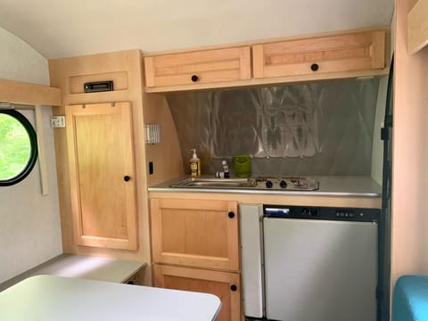 But there's a little more counter space when you use the table & the bench below the cute porthole window-it's a 1 butt kitchenette! 5'9" int. height
