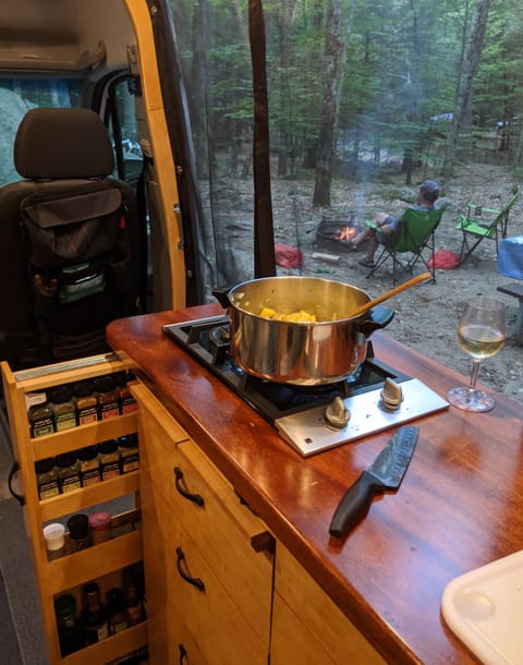 Mahogany counter top, hard maple cabinets, 2 burner propane stove with one high BTU burner and a second smaller burner.