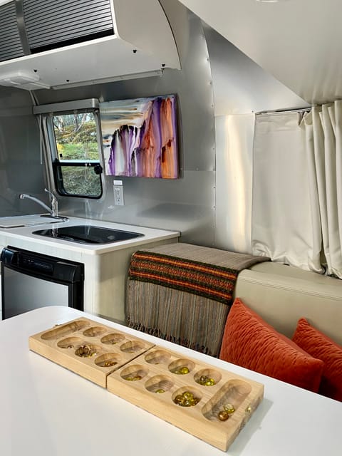 Time to chill in the Airstream after a day of exploring... books, mancala, journaling, scrabble, or maybe planning your next adventure?